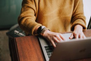 woman typing on laptop