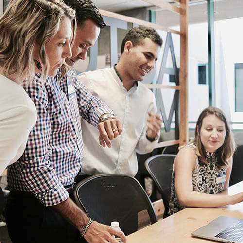 group of office workers in front of computer