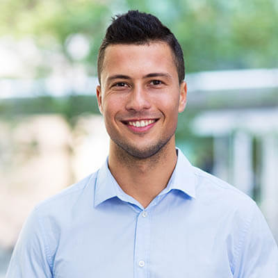 young guy in blue shirt smiling